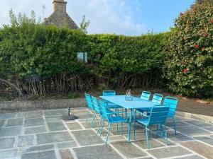 a blue table and chairs on a patio at Charming holiday home near the beach, Locquirec in Locquirec