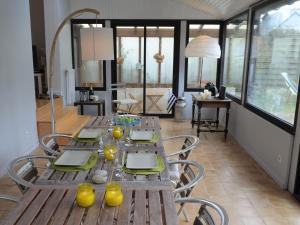 a dining room with a wooden table and chairs at Charming holiday home near the beach, Locquirec in Locquirec