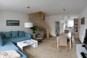 a living room with a blue couch and a table at Marina 22 in Cuxhaven