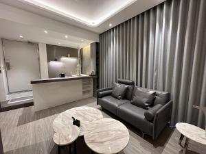 a living room with a couch and a table at Starhaus Hotel in Kaohsiung