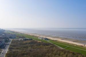 an aerial view of a beach next to the water at Strandhochhaus 5 in Döse