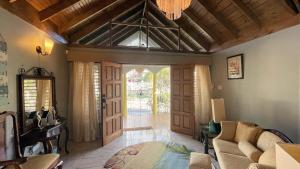 a living room with an open door and a couch at Yancey Largo Villa with Private Pool in Montego Bay +97 photos