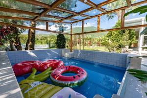 ein Swimmingpool mit zwei aufblasbaren Spielgeräten in einem Haus in der Unterkunft 雲上太陽villa-KTV烤肉 in Zhixue