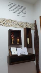 a shelf with two figurines on top of a wall at El Quijote Apartahotel in Jericó