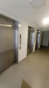 an empty hallway with elevators in a building at Reservas altos de huayquique in Iquique