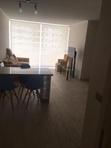 a living room with a table and chairs and a couch at DEPARTAMENTO EN LA SERENA A PASOS DE LA PLAYA in La Serena