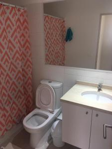a bathroom with a toilet and a sink at DEPARTAMENTO EN LA SERENA A PASOS DE LA PLAYA in La Serena
