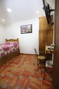 a bedroom with a bed and a table and a chair at Hotel Boutique Casa Elefante in Guadalajara