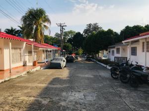 an empty street in a town with houses and motorcycles at EL DESCANSO DEL HACARITAMA in Melgar