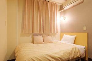Postel nebo postele na pokoji v ubytování Hotel Suntargas Ueno