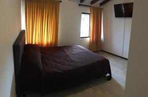 Tempat tidur dalam kamar di SAN NICOLAS