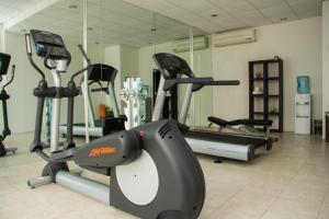 a gym with several cardio machines in a room at Mesón de la Luna Hotel & Spa in Mérida