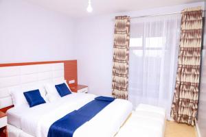 Säng eller sängar i ett rum på Luxe Furnished Apartments Unit 9
