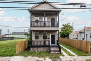 a house with a balcony and a fence at Vibrant Blue Luxury Loft 2316 in New Orleans