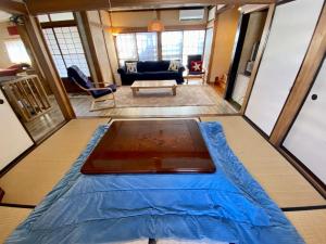 a view of a living room with a bed and a couch at Ishimaru House in Seki