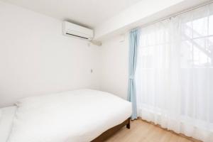Ένα ή περισσότερα κρεβάτια σε δωμάτιο στο Kyoto Lanlan Villa