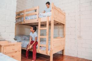 two boys sitting on bunk beds in a room at Hacienda CacaoyMango in Naranjal