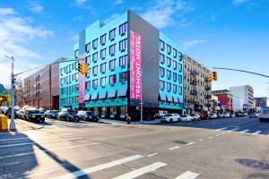 um cruzamento de uma rua da cidade com um edifício em Hotel TREMONT Bronx Yankee Stadium em Bronx