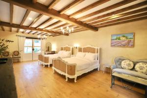a large bedroom with two beds and a couch at Moon River Village in Ban Bu Khanun