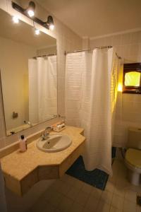 a bathroom with a sink and a white shower curtain at Abouseif Guest House in Sharm El Sheikh