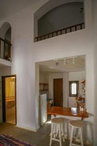 a kitchen with a table and two stools around it at Abouseif Guest House in Sharm El Sheikh