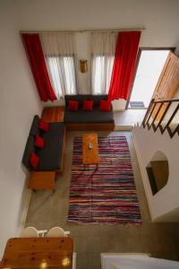 a living room with a black couch and red curtains at Abouseif Guest House in Sharm El Sheikh
