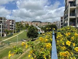 a row of apartment buildings with yellow flowers in a park at Jewel of the East in Ceiba