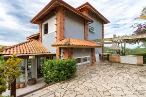 a house with a tile roof and a patio at Praia de Geriba - Fantastica Vista Mar in Búzios