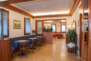 a restaurant with tables and chairs in a room at La Vigneta in Arsiero
