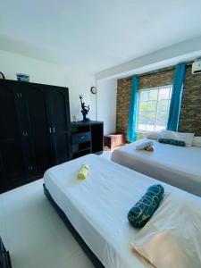 Un dormitorio con dos camas y una ventana. en Apartamentos Sweet Island, en San Andrés
