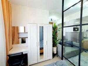 a room with a white cabinet and a glass wall at Green 2 Residences Scandi-Industrial Hotel Type Interior in Dasmariñas