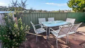 a patio with a table and chairs and a fence at Relaxing Home Close to Nature in Bunbury