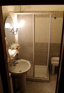 a bathroom with a shower and a sink at Dominus Hotel in Sigillo