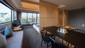 a hotel room with a couch and a table with chairs at Minn Nijo-jo in Kyoto