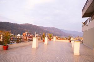 a balcony with a view of the water and mountains at Hotel Triple Hill in Pokhara