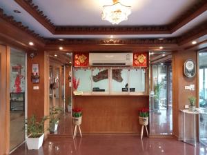 a lobby of a building with plants and a chandelier at KC Place Srinakarin in Bangna