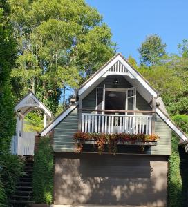 ein Haus mit einem Balkon mit Blumen darauf in der Unterkunft Mountain Studio Escape in Mount Tamborine