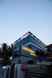 a building with a sign on the side of it at Kausthubhom Residency in Tiruvalla