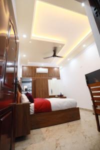 a bedroom with a bed with a red blanket at Kausthubhom Residency in Tiruvalla