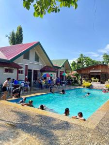 a group of people swimming in a swimming pool at Angela's Pool Resort in Puerto Princesa City +24 photos
