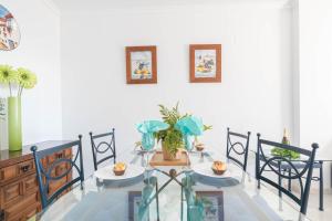 a dining room with a table and two chairs at Mi Capricho beach front sea view & pool - Happy Rentals in Mijas Costa
