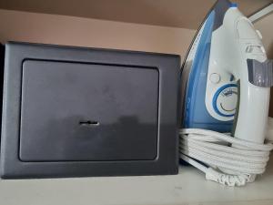 a tv sitting on top of a counter with a remote control at Accommodation Sydney - Hyde Park Plaza in Sydney