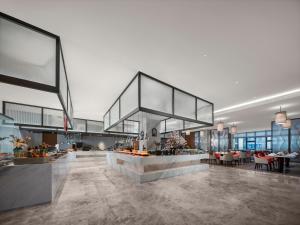 a lobby with a bar in the middle of a building at Grand New Century Hotel Wenzhou in Wenzhou