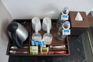 a shelf with toothbrushes and bottles of water and other items at Centara Life Government Complex Hotel & Convention Centre Chaeng Watthana in Bangkok