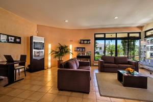 a living room with two couches and a table at Baia da Luz Resort in Luz