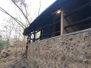 a building on top of a stone wall at Sundowner Lodge in Hwange