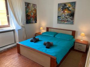 a bedroom with a blue bed with two pillows at Apartment Mirna - what you see is what you get in Opatija