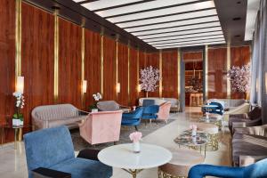 a lobby with blue chairs and tables and chairs at 33 Seaport Hotel New York in New York
