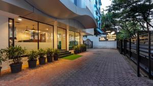a building with potted plants in front of it at Magnus Riverside Kalyani Nagar, Pune in Pune