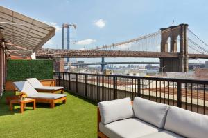 a balcony with two couches and a bridge at 33 Seaport Hotel New York in New York